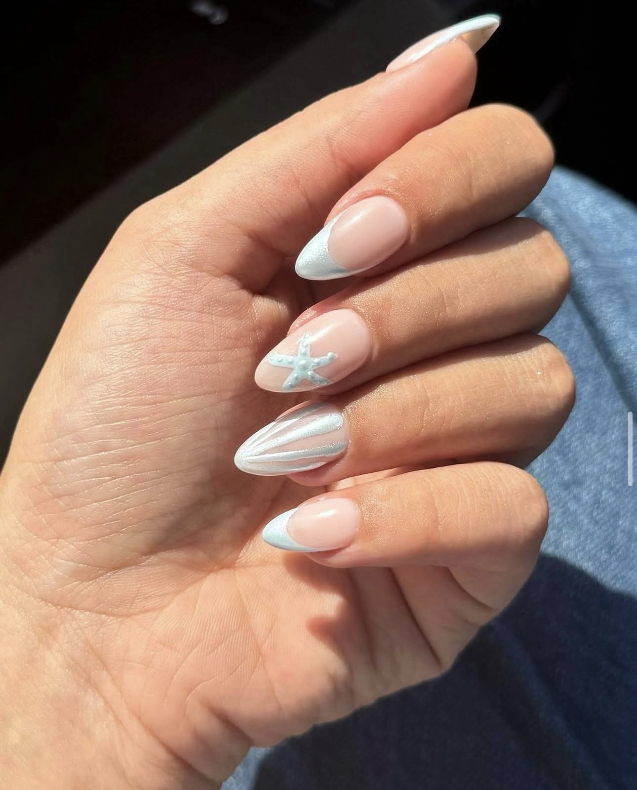 Ocean-theme French tip nails with starfish